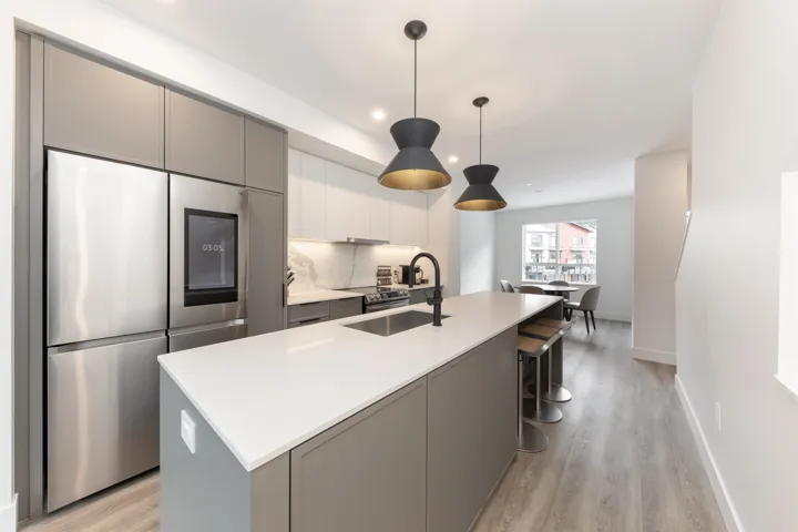 Kitchen with smart refrigerator, light countertops, light wood finished floors, a sink, and gray cabinets
