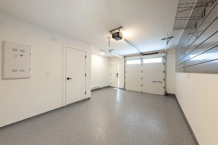 Garage with a garage door opener and baseboard heating