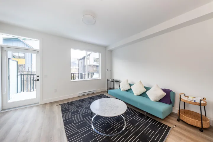Living area featuring wood finished floors, baseboards, and baseboard heating