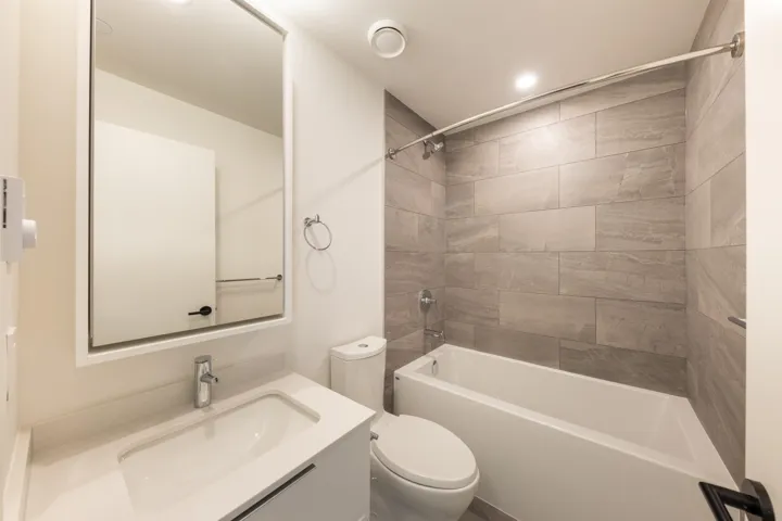 Full bathroom featuring toilet, vanity, and shower / bathtub combination