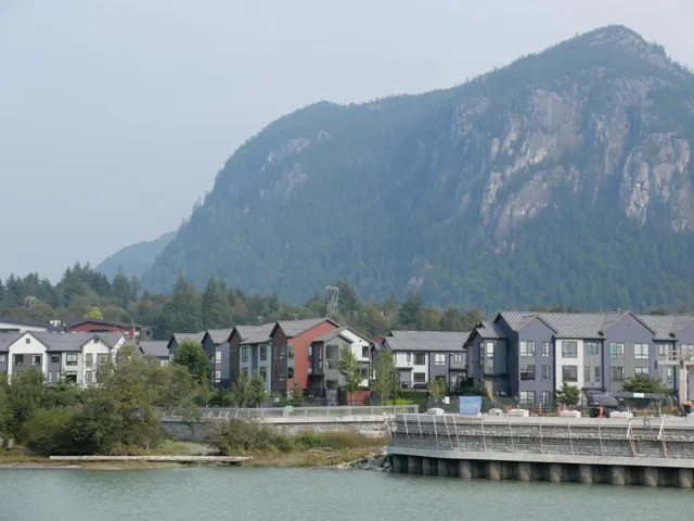 View of mountain backdrop with nearby suburban area and a large body of water