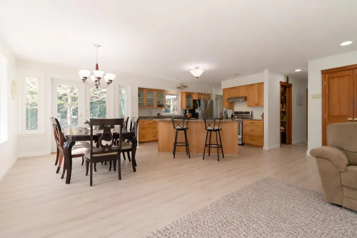 Dining space with light wood-style flooring and a chandelier