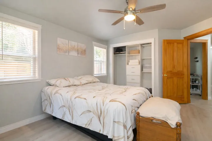 Bedroom featuring a closet, a ceiling fan, and light wood finished floors