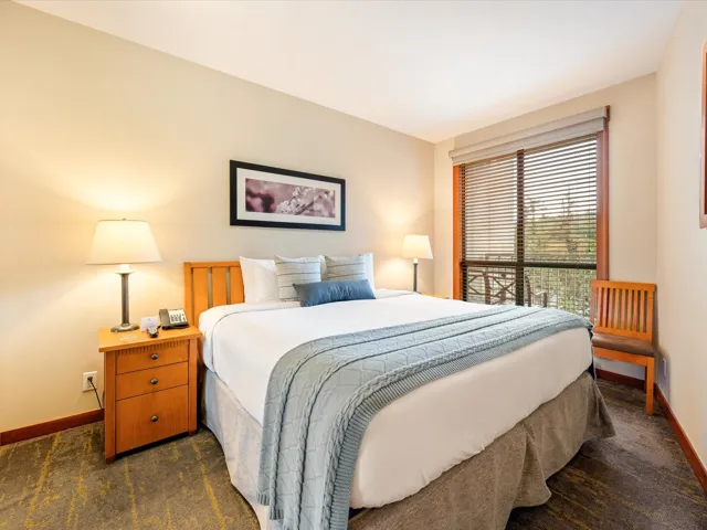 Bedroom featuring dark carpet and baseboards