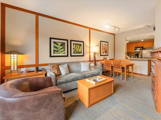 Living area with track lighting and carpet flooring