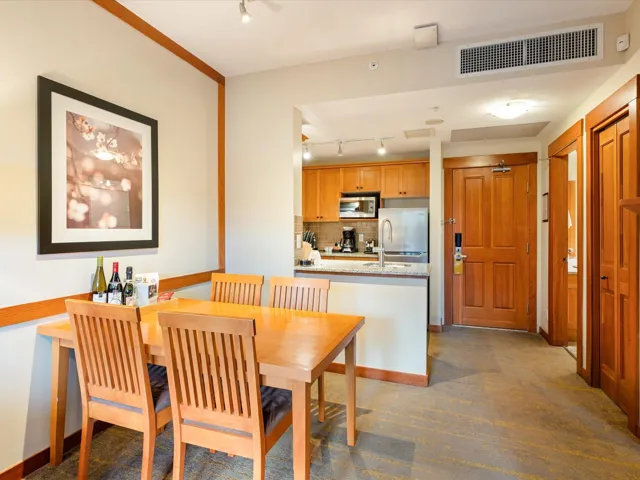 Dining room featuring rail lighting and dark colored carpet