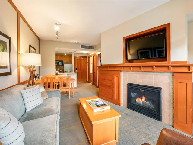Living room featuring dark colored carpet and a tile fireplace