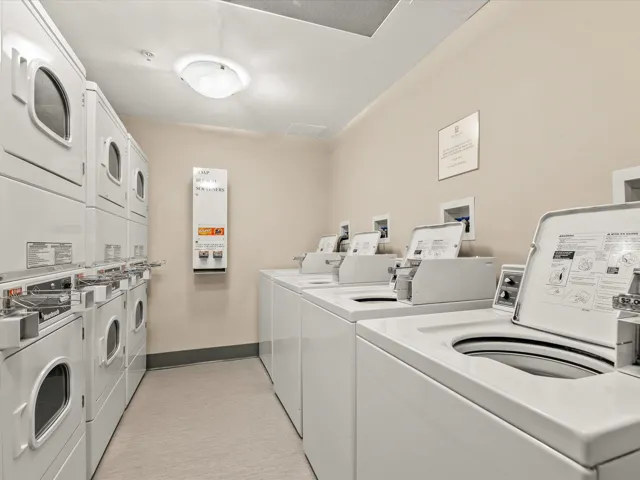 Shared laundry featuring stacked washing machine and dryer and washing machine and clothes dryer