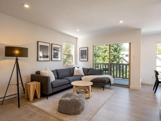 Living room with a baseboard radiator, recessed lighting, a wealth of natural light, and wood finished floors