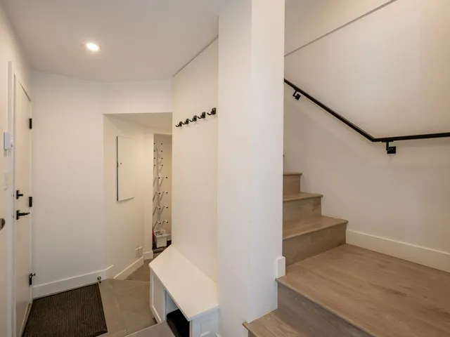 Stairs with recessed lighting, wood finished floors, and baseboards