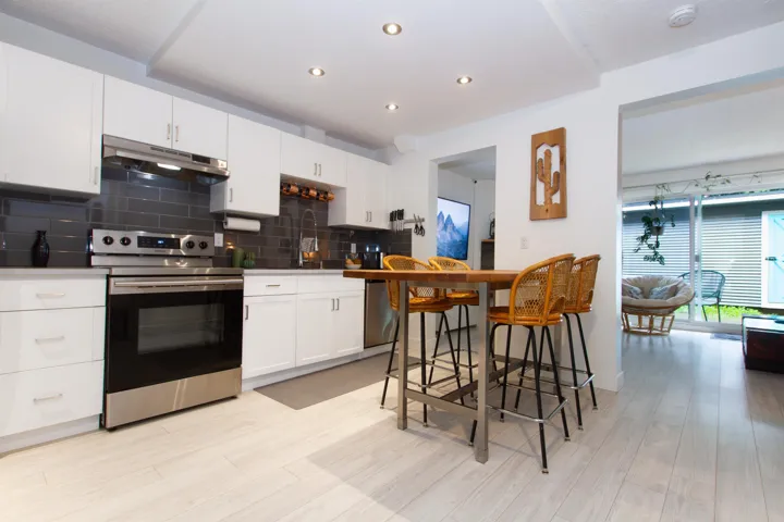 Open kitchen with stainless steel appliances.