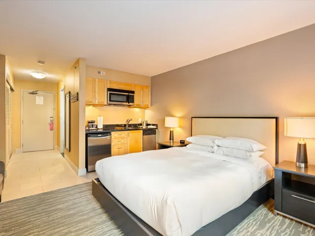 Bedroom featuring light tile patterned floors and baseboards