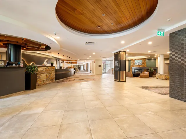 Building lobby with wooden ceiling and recessed lighting