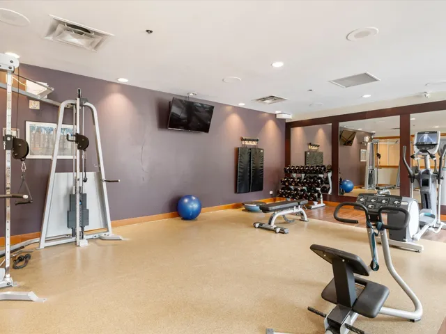Exercise room with baseboards and recessed lighting