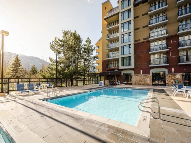Community pool with a mountain view and a patio area