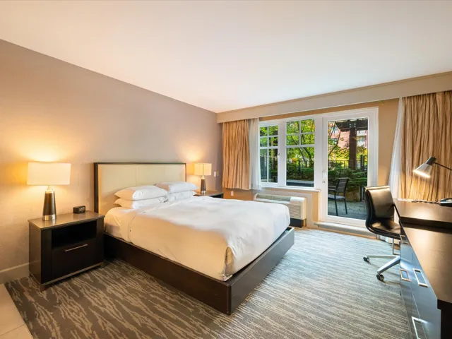 Bedroom with access to outside and a desk