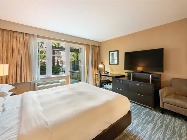 Bedroom featuring access to exterior and a wall mounted AC