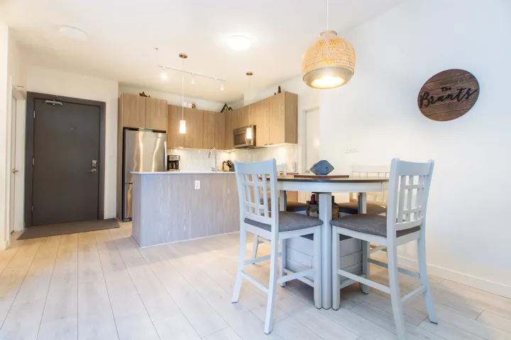Dining area featuring light wood-style flooring and baseboards