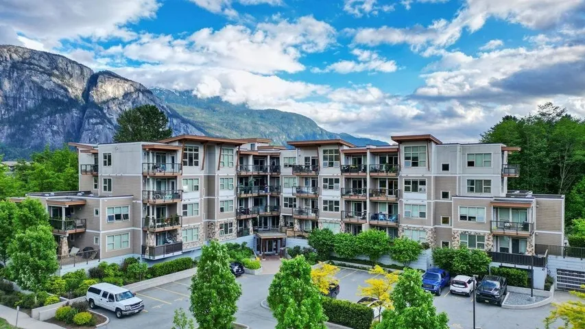View of building exterior with uncovered parking and a mountain view