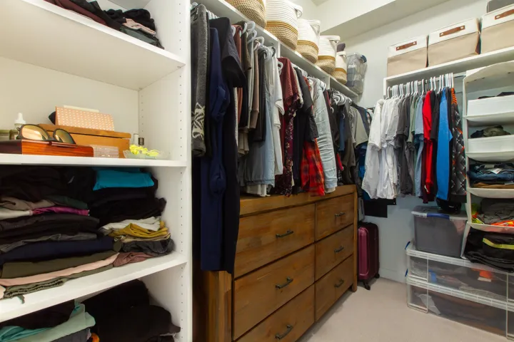 Spacious closet with light colored carpet