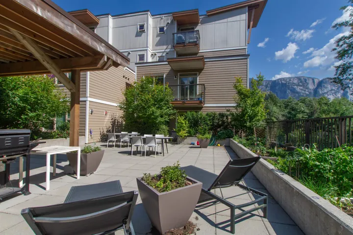 View of patio with a balcony, a grill, fence, outdoor dining area, and a mountain view