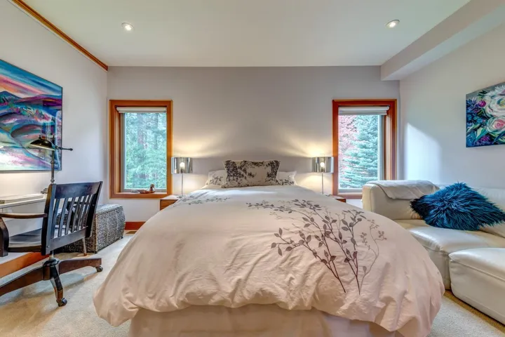Bedroom featuring multiple windows, light colored carpet, and recessed lighting