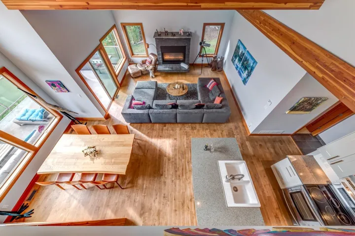 Living area with wood finished floors and a glass covered fireplace