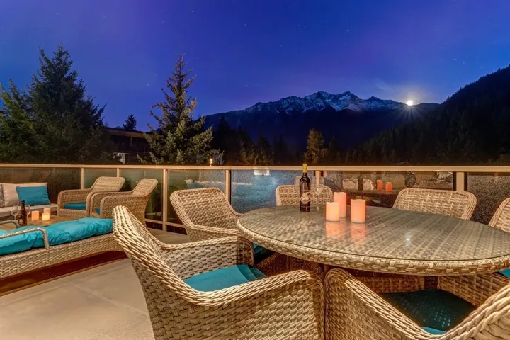 Patio at twilight featuring outdoor dining area and a mountain view