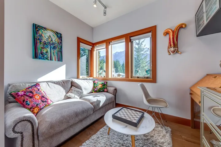 Living room featuring wood finished floors, baseboards, and track lighting