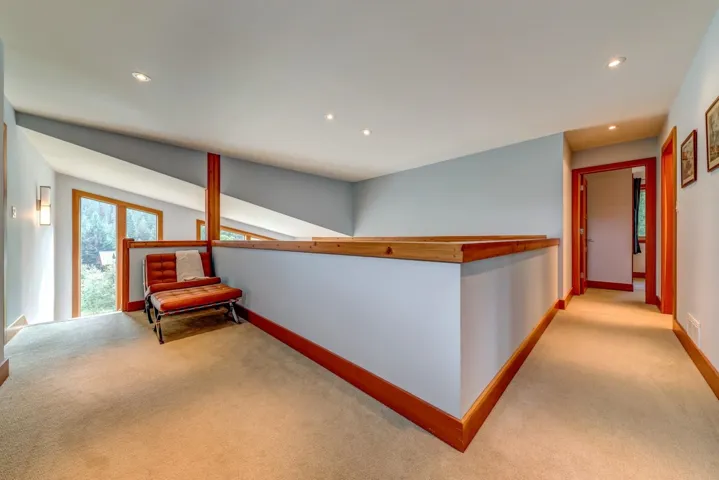 Hallway with carpet, recessed lighting, and baseboards