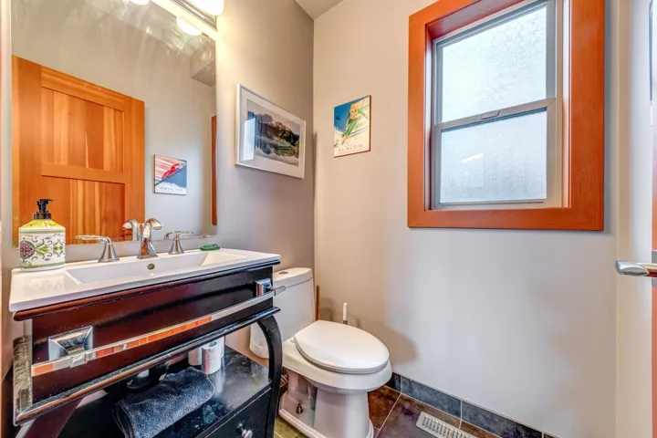 Bathroom featuring toilet, vanity, and tile patterned flooring