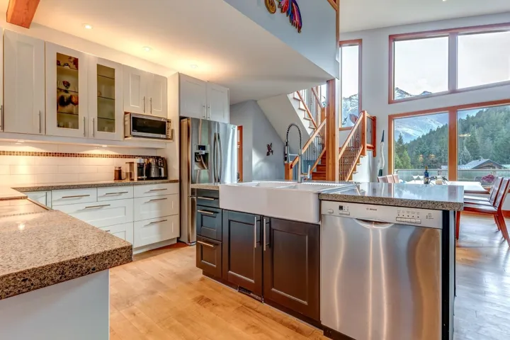 Kitchen featuring appliances with stainless steel finishes, a sink, healthy amount of natural light, light wood-type flooring, and recessed lighting