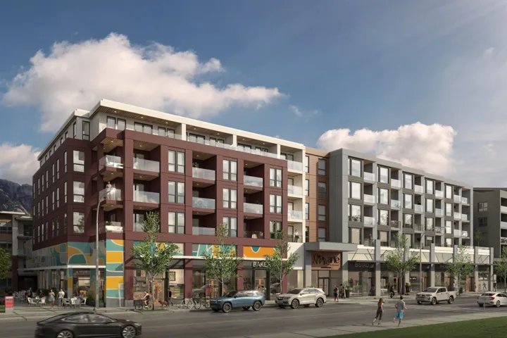 Modern multi-story building featuring ground-level retail spaces, residential balconies with glass railings, a contemporary brick facade, and large windows