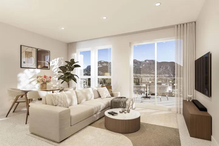 Bright living area featuring expansive sliding glass doors opening to an outdoor patio with mountain scenery