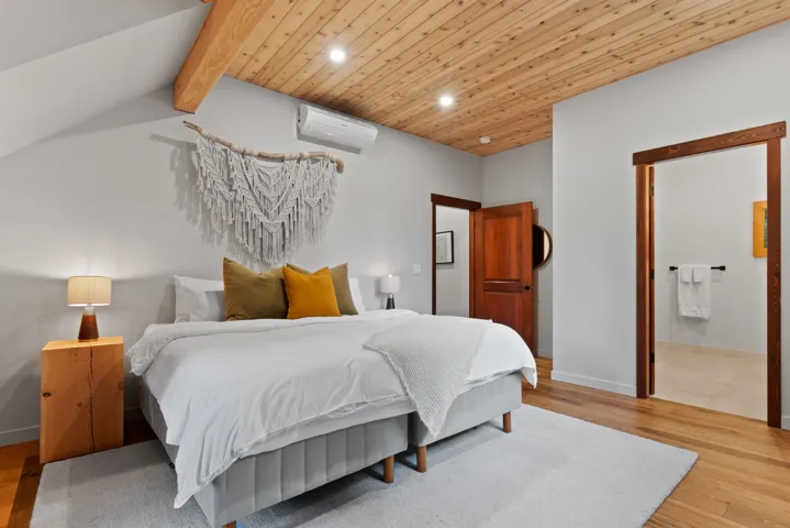 Bedroom with wood finished floors, recessed lighting, a wall unit AC, wooden ceiling, and lofted ceiling with beams