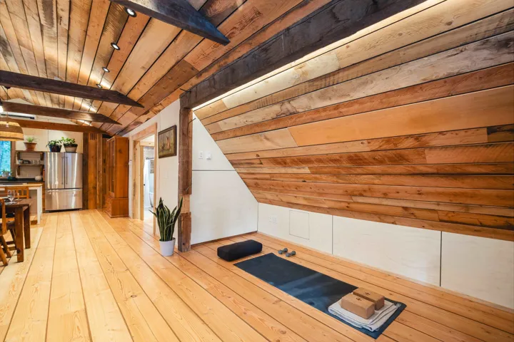 Bonus room with wooden ceiling, vaulted ceiling with beams, and light wood-type flooring
