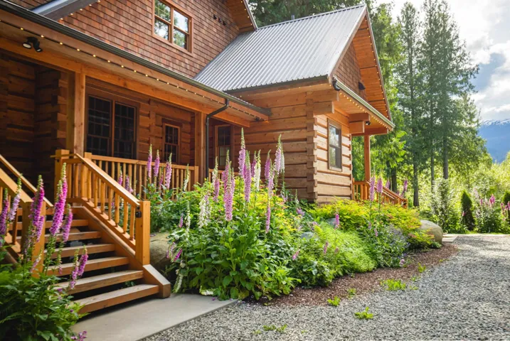 View of home's exterior featuring log siding and metal roof