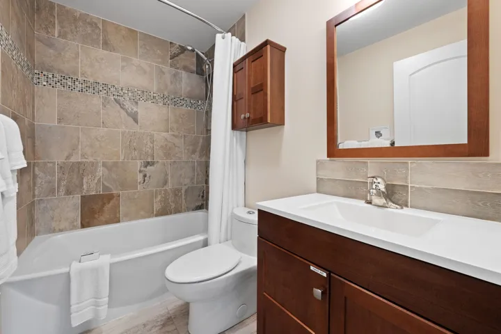 Full bath with vanity.