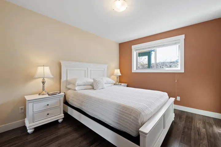 Bedroom with baseboards and dark wood-style flooring