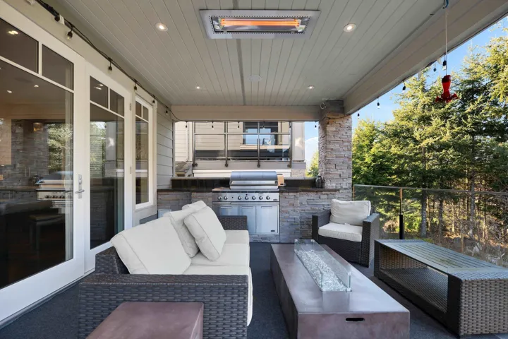 Balcony off the kitchen with built in BBQ, heating lamp and hot tub.  Beautiful private views.
