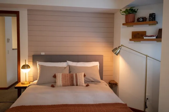 Paneled accent wall with a neutral-toned headboard