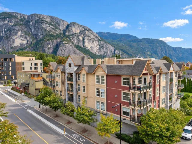 Multi-story residential building with private balconies and gable roofs
