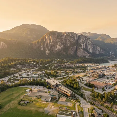 Mountainous landscape framing a developed community with a prominent river