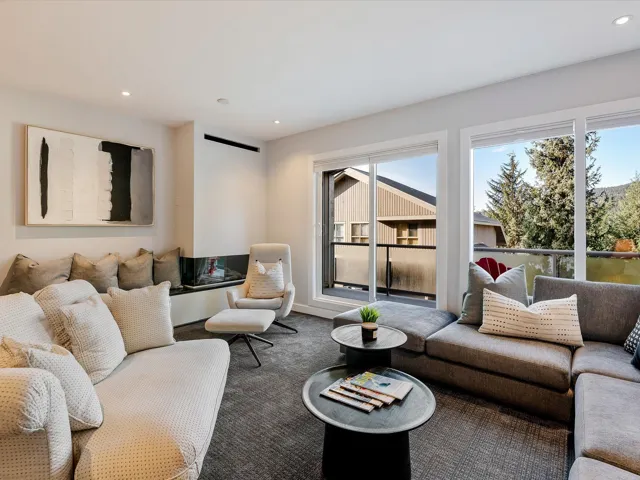 Living area with recessed lighting and carpet floors
