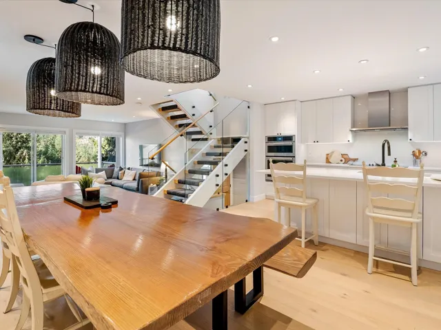 Dining space with light wood-style flooring, recessed lighting, and stairway