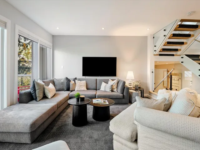 Living room featuring recessed lighting and stairs