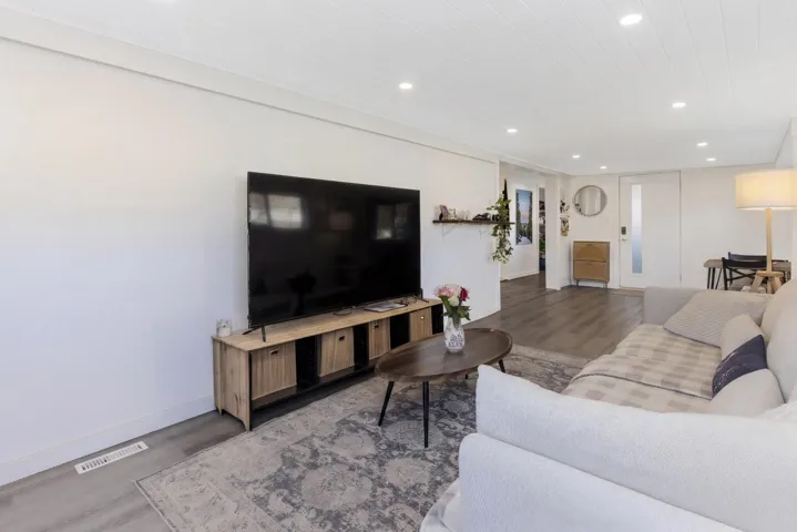 Living room featuring wood finished floors and recessed lighting