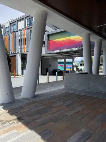 Modern exterior featuring a prominent sign with colorful mountain artwork