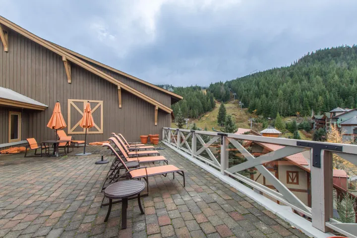 View of patio with a view of trees and a mountain view