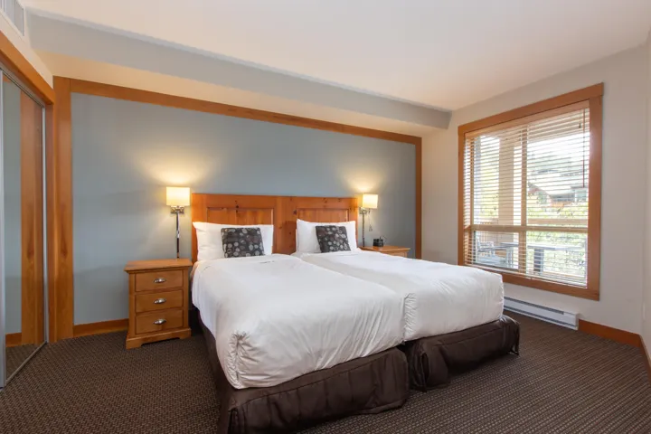 Bedroom with a baseboard radiator, dark colored carpet, baseboards, and a closet